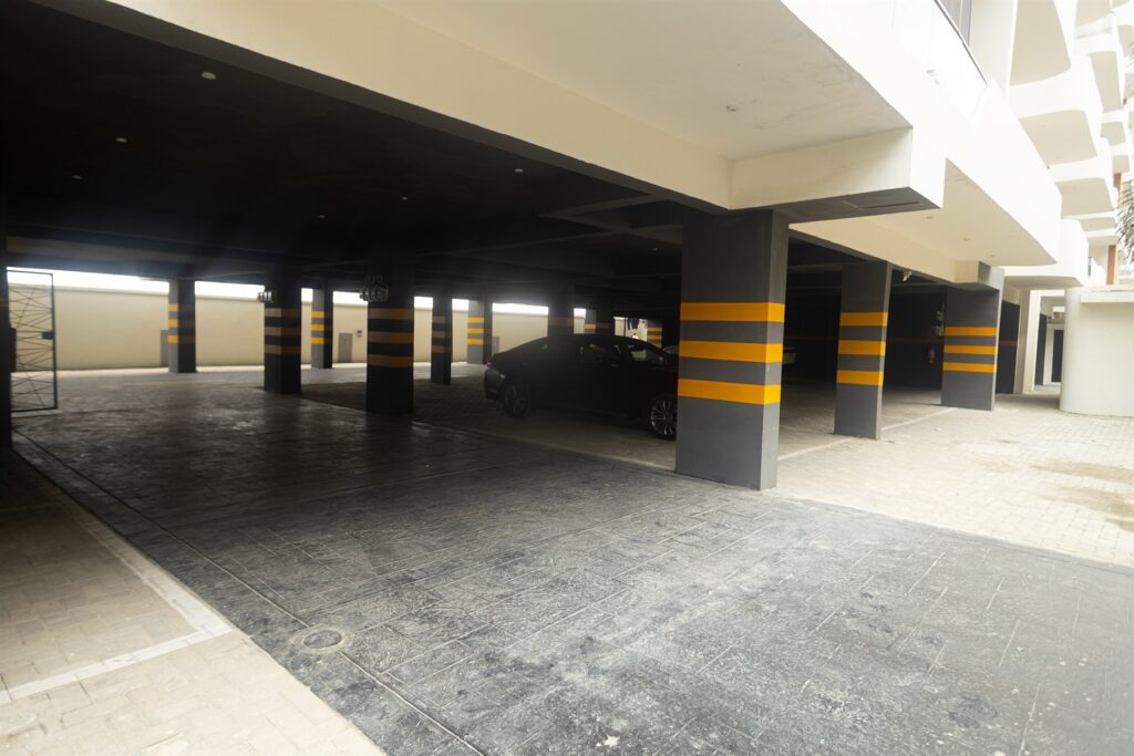 Brum Height 7: Covered parking area with yellow-striped support columns